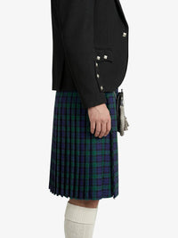 Person wearing a black blazer and a plaid kilt on a white background