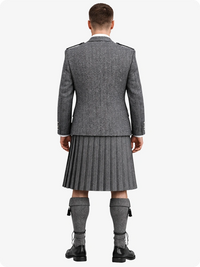 Person wearing a gray Highland kilt with a jacket on a white background