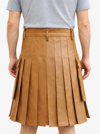 Person wearing a tan pleated skirt on a white background