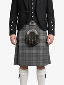 Person wearing a traditional Scottish kilt with a sporran on a white background