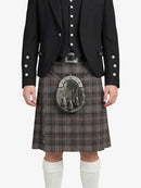 Person wearing a traditional Scottish kilt with a sporran on a white background