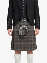 Person wearing a traditional Scottish kilt with a sporran on a white background