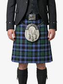 Person wearing a traditional Scottish kilt with a tartan pattern on a white background