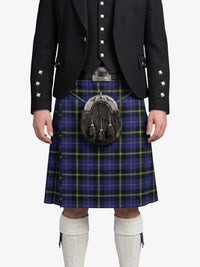 Person wearing a traditional Scottish kilt with a jacket on a white background