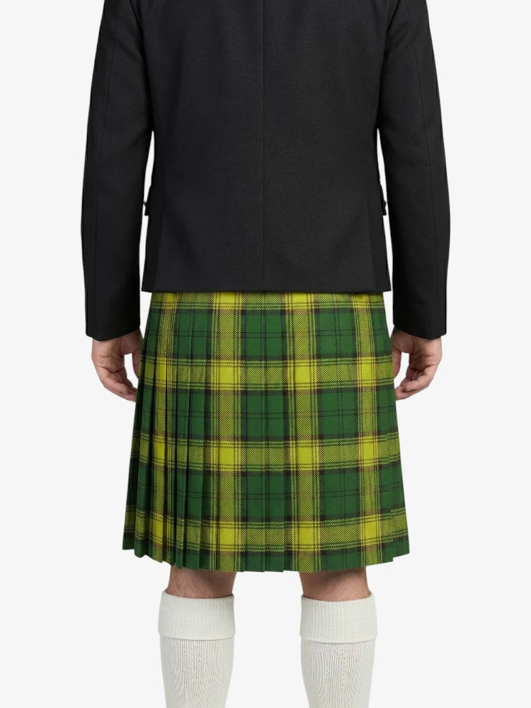 Person wearing a green plaid kilt with a black jacket on a white background