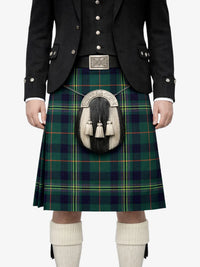Person wearing a traditional Scottish kilt with a tartan pattern on a white background