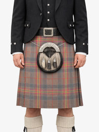 Person wearing a traditional Scottish kilt with a sporran on a white background