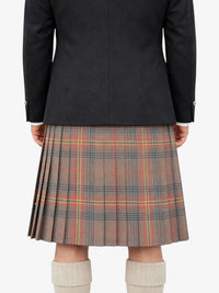 Person wearing a black jacket and plaid kilt on a white background