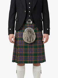 Person wearing a traditional Scottish kilt with a jacket on a white background