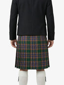Person wearing a black jacket and plaid kilt on a white background