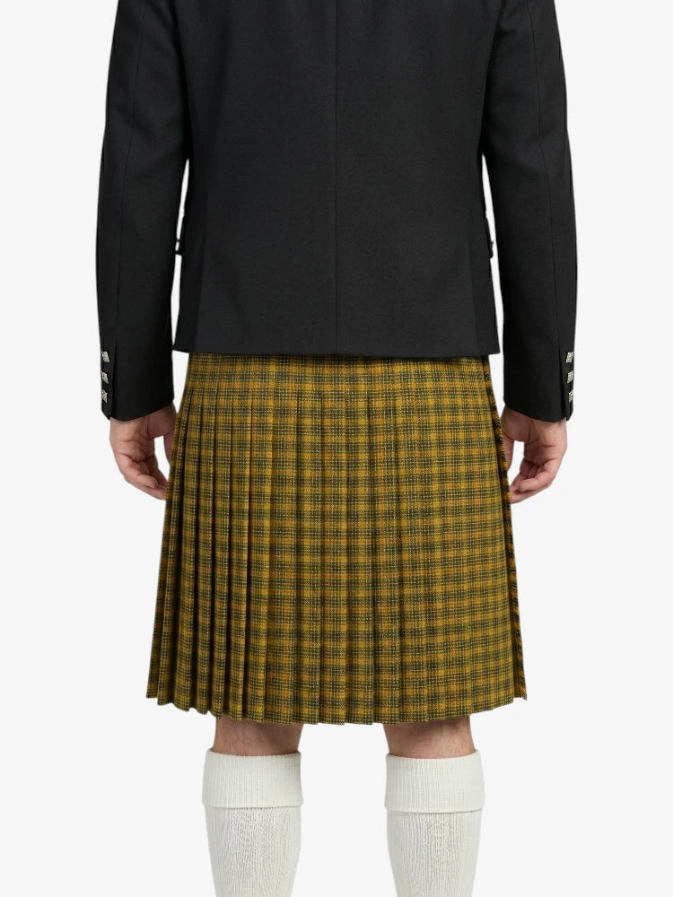Person wearing a black jacket and plaid kilt on a white background