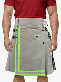 Person wearing a gray kilt with green accents on a white background