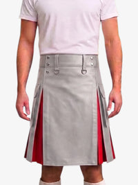 A person wearing a light gray pleated kilt with red side panels and silver buckle details, paired with a pale pink t-shirt against a plain light background.