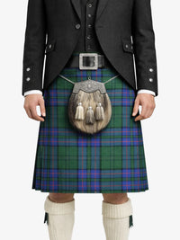 Person wearing a traditional Scottish kilt with a tartan pattern on a white background