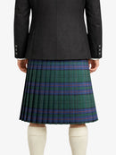 Person wearing a black jacket and green plaid kilt on a white background