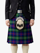 Person wearing a traditional Scottish kilt with a tartan pattern on a white background