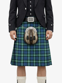 Person wearing a traditional Scottish kilt with a sporran on a white background