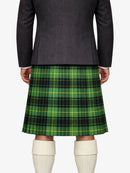 Person wearing a dark gray jacket and green plaid kilt on a white background