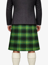 Person wearing a dark gray jacket and green plaid kilt on a white background
