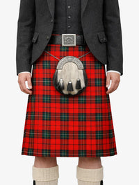 Person wearing a red plaid kilt with a gray jacket and white socks on a white background