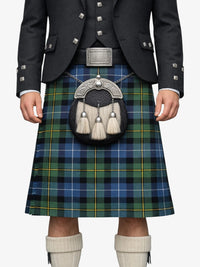 Person wearing a traditional Scottish kilt with a tartan pattern on a white background