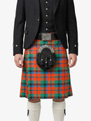 Person wearing a traditional Scottish kilt with a tartan pattern on a white background