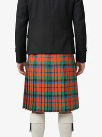 Person wearing a black jacket and a red plaid kilt on a white background