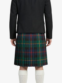 Person wearing a black jacket and plaid kilt on a white background