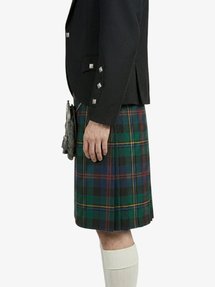 Person wearing a black jacket and green plaid kilt on a white background