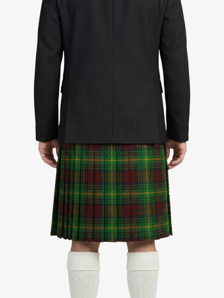 Person wearing a black coat and green plaid kilt on a white background