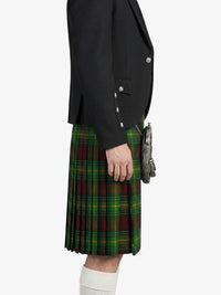 Person wearing a black blazer and green plaid kilt on a white background