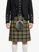 Person wearing a traditional Scottish kilt with a jacket on a white background
