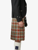 Person wearing a black jacket and plaid kilt on a white background