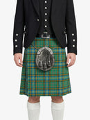 Person wearing a black jacket with white buttons and a green plaid kilt on a white background