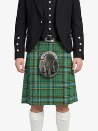 Person wearing a black jacket with white buttons and a green plaid kilt on a white background