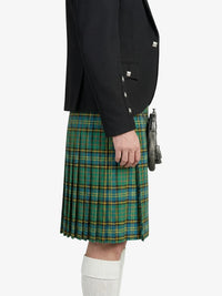 Person wearing a black jacket and green plaid kilt on a white background