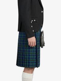 Person wearing a black jacket and green plaid kilt on a white background