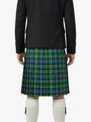 Person wearing a black jacket and green plaid kilt on a white background