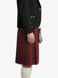 Person wearing a black jacket and red plaid kilt on a white background