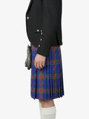 Person wearing a black jacket and blue plaid kilt on a white background