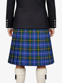 Person wearing a dark jacket and blue plaid kilt on a white background