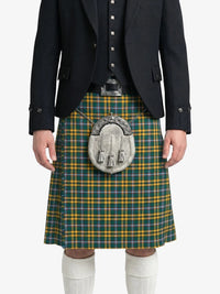 Person wearing a green and yellow plaid kilt with a dark jacket on a white background