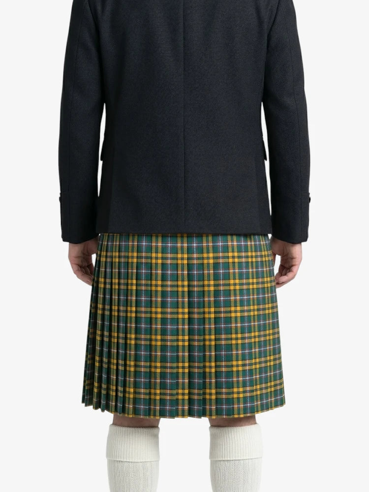 Person wearing a black coat and green plaid kilt on a white background