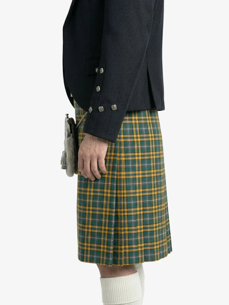 Person wearing a dark jacket and green plaid kilt on a white background