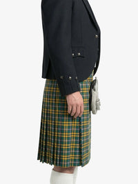 Person wearing a dark jacket and green plaid kilt on a white background
