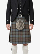 Traditional Scottish kilt with a tartan pattern worn by a person on a white background