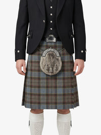 Traditional Scottish kilt with a tartan pattern worn by a person on a white background