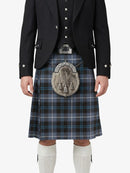 Person wearing a traditional Scottish kilt with a jacket on a white background