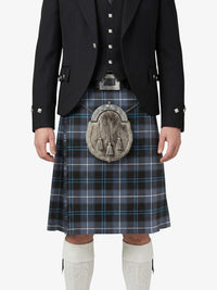 Person wearing a traditional Scottish kilt with a jacket on a white background
