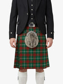Person wearing a traditional Scottish kilt with a tartan pattern on a white background